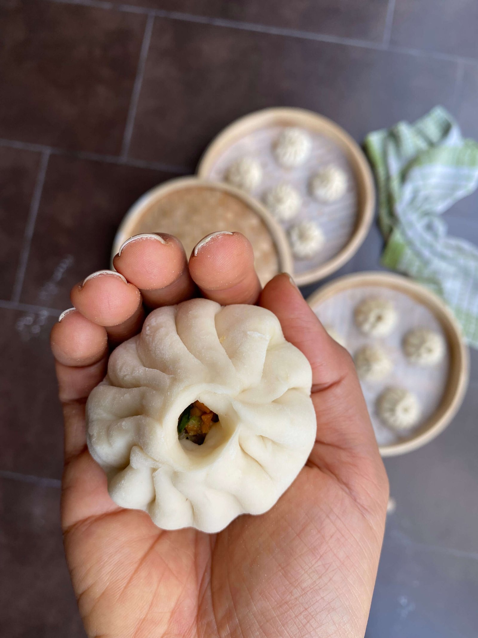 Steaming hot bamboo baskets filled with soft, pleated Baozi
